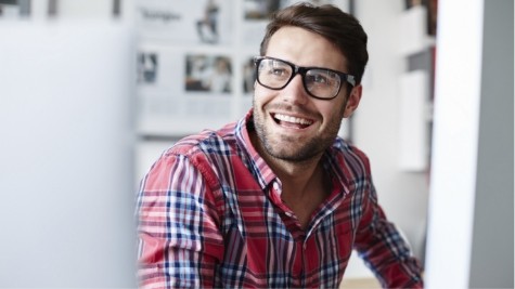 Smiling man with glasses and red plaid shirt