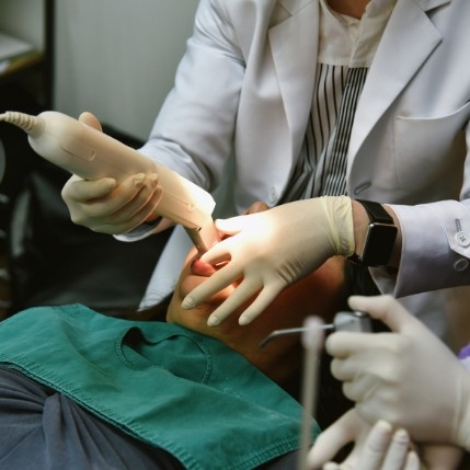 Dentist capturing impressions of teeth with a digital scanner