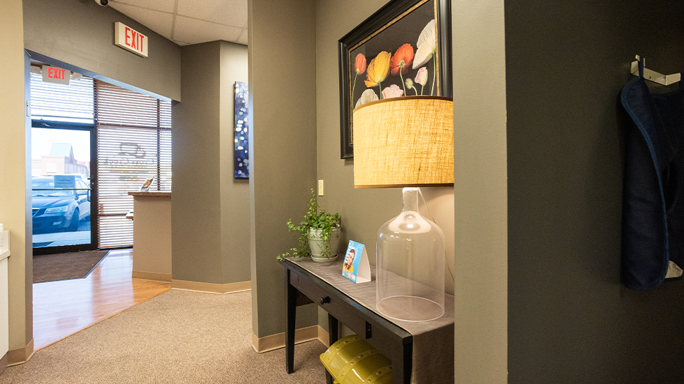 Reception area visible through door in hallway