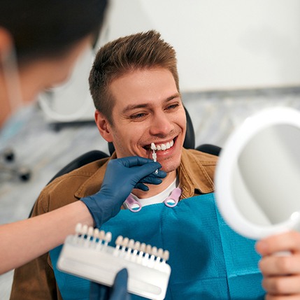 a close-up of dental veneers against a blue background
