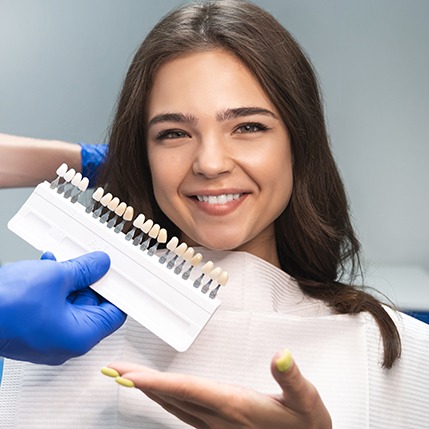 a patient smiling after receiving veneers