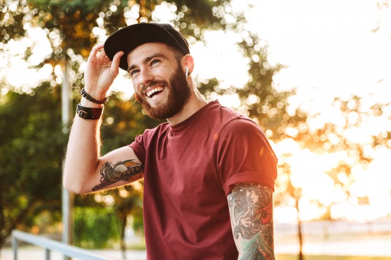 A handsome, smiling man in an outdoor setting